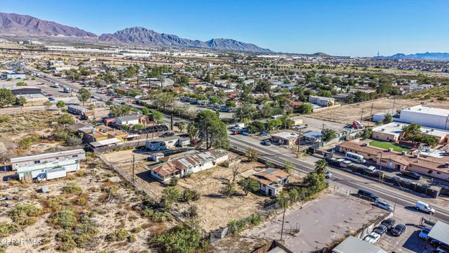 an aerial view of residential houses with city view