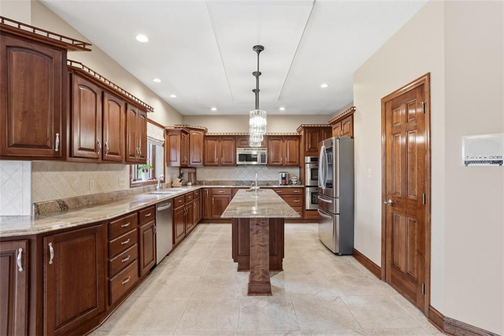 109 Brookside Lane Coraopolis, PA 15108 - Photo 12 of 50 a large kitchen with stainless steel appliances kitchen island granite countertop a refrigerator and a sink