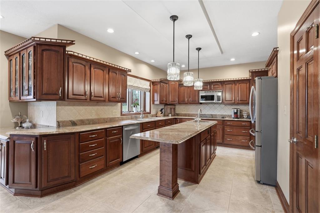 109 Brookside Lane Coraopolis, PA 15108 - Photo 13 of 50 a kitchen with stainless steel appliances granite countertop a sink a stove and a wooden floors