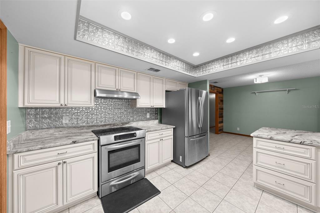 2645 Southeast 162nd Place Road Summerfield, FL 34491 - Photo 14 of 38 a kitchen with a stove sink and refrigerator