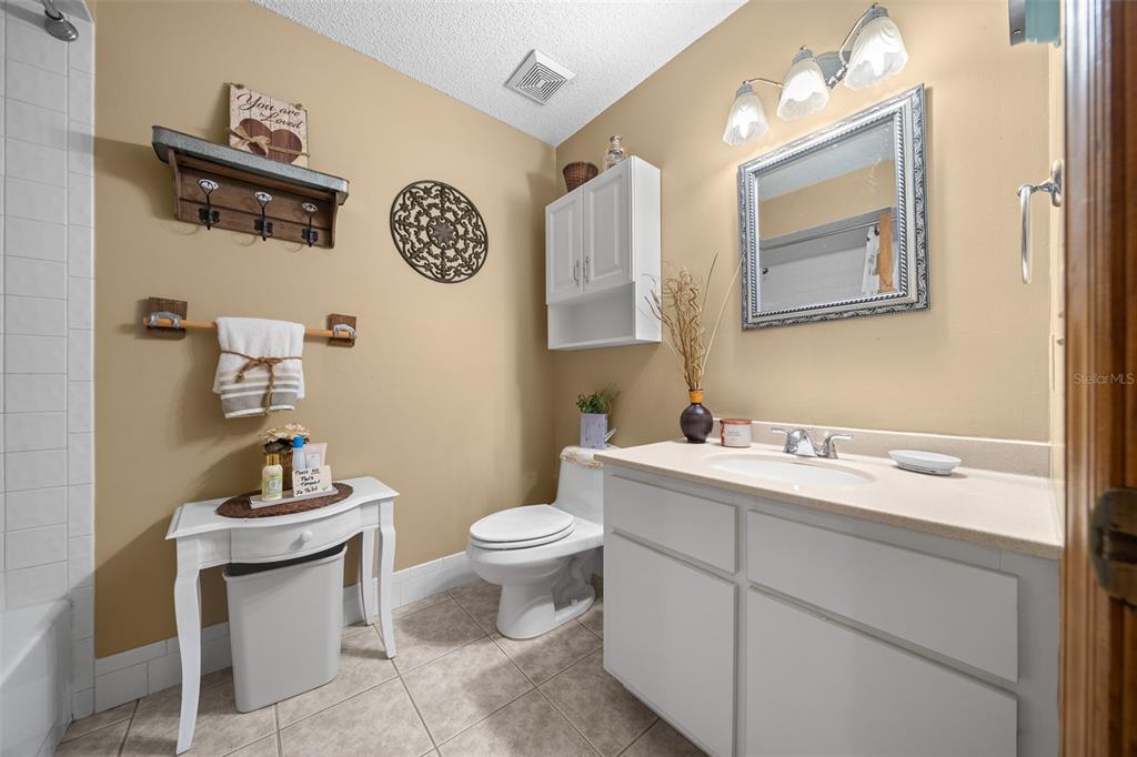 2645 Southeast 162nd Place Road Summerfield, FL 34491 - Photo 17 of 38 a bathroom with a toilet a sink and mirror