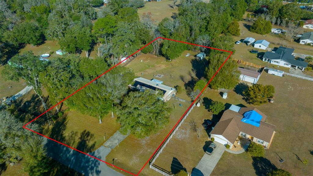 2645 Southeast 162nd Place Road Summerfield, FL 34491 - Photo 37 of 38 an aerial view of a house with a yard and large trees