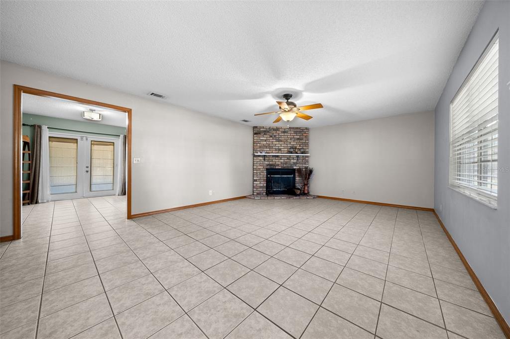 2645 Southeast 162nd Place Road Summerfield, FL 34491 - Photo 6 of 38 a view of empty room with window and fireplace