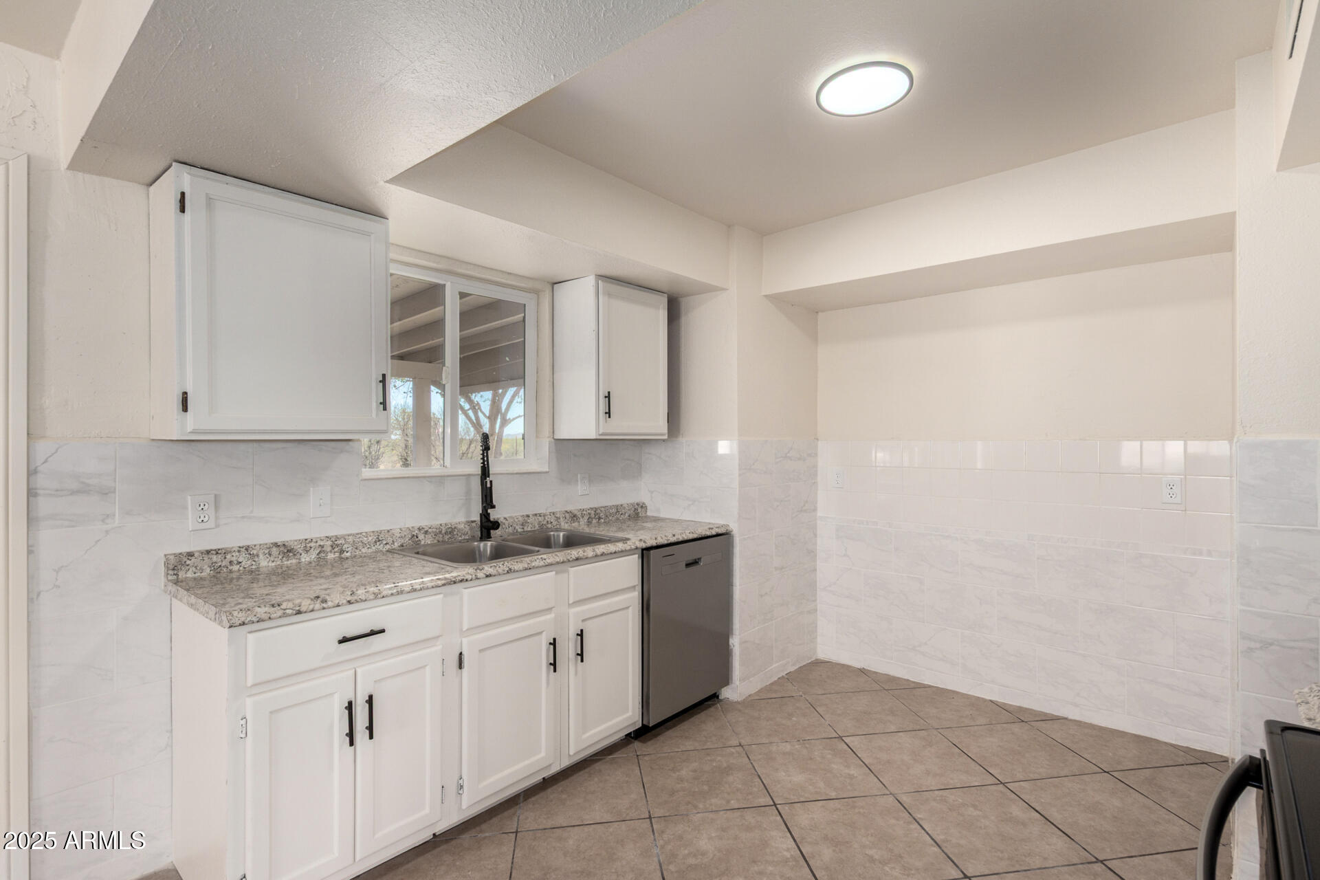 3613 East White Tail Road Pearce, AZ 85625 - Photo 12 of 39 a kitchen with granite countertop a sink and cabinets