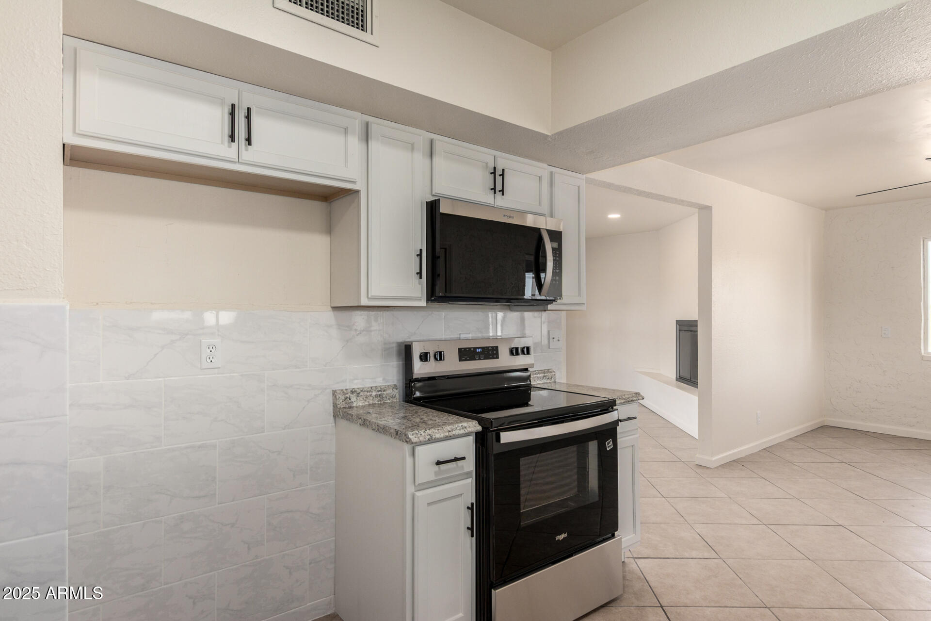 3613 East White Tail Road Pearce, AZ 85625 - Photo 15 of 39 a kitchen with stainless steel appliances a stove a microwave and a sink