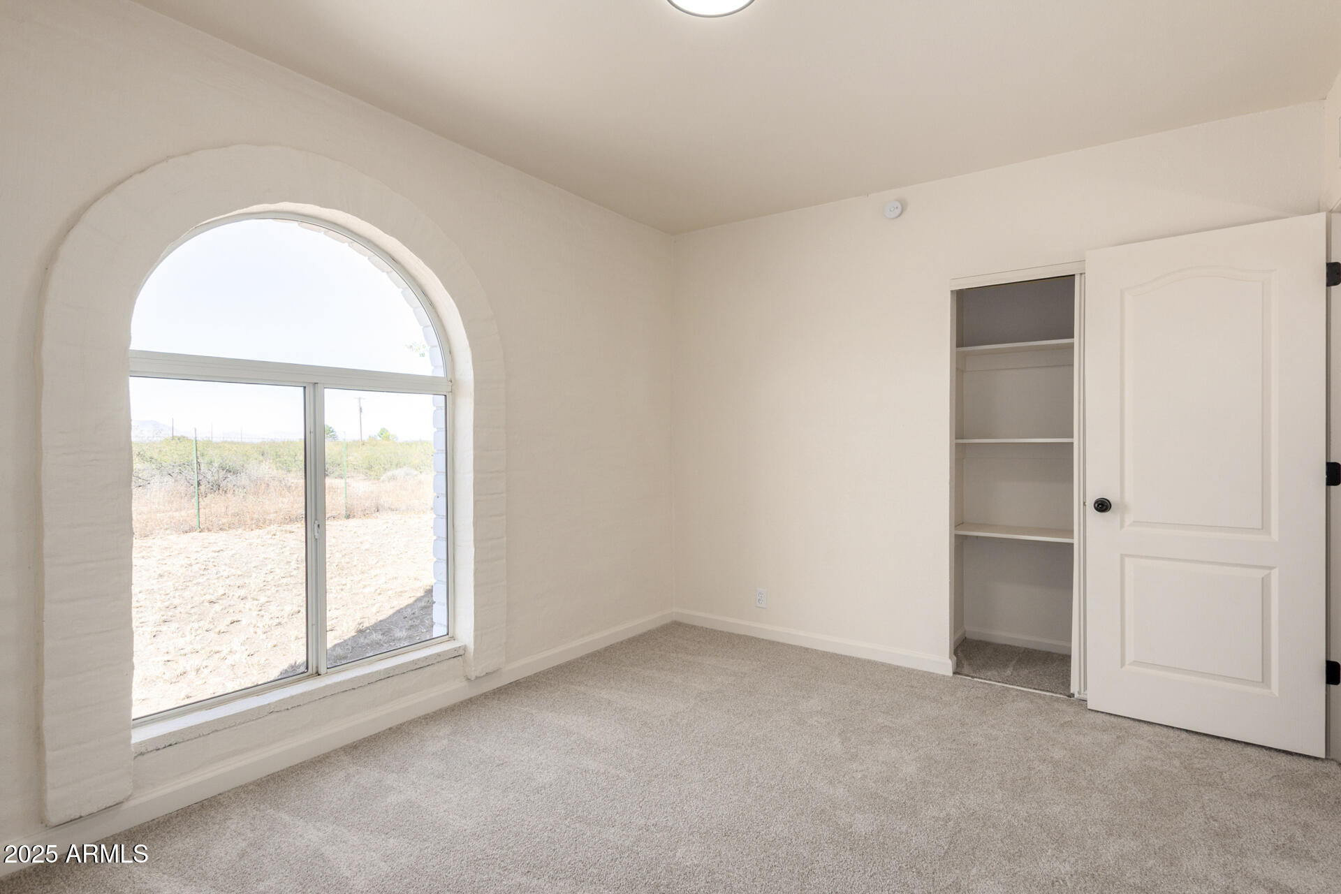 3613 East White Tail Road Pearce, AZ 85625 - Photo 21 of 39 an empty room with a window