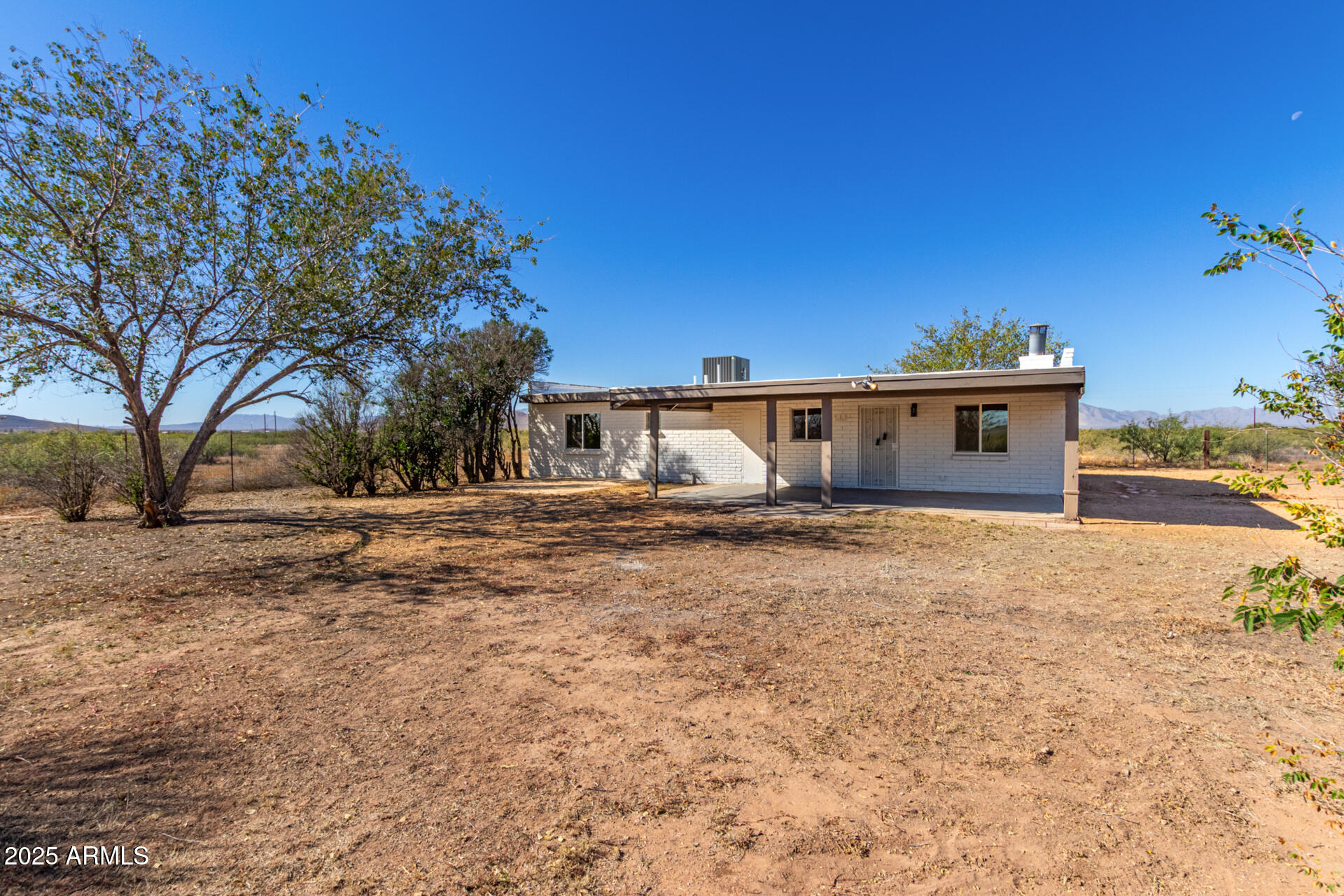 3613 East White Tail Road Pearce, AZ 85625 - Photo 32 of 39 a front view of a house with a yard and garage