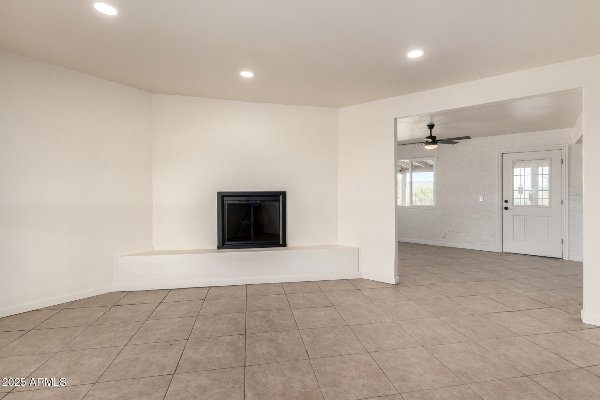3613 East White Tail Road Pearce, AZ 85625 - Photo 7 of 39 an empty room with windows and fireplace