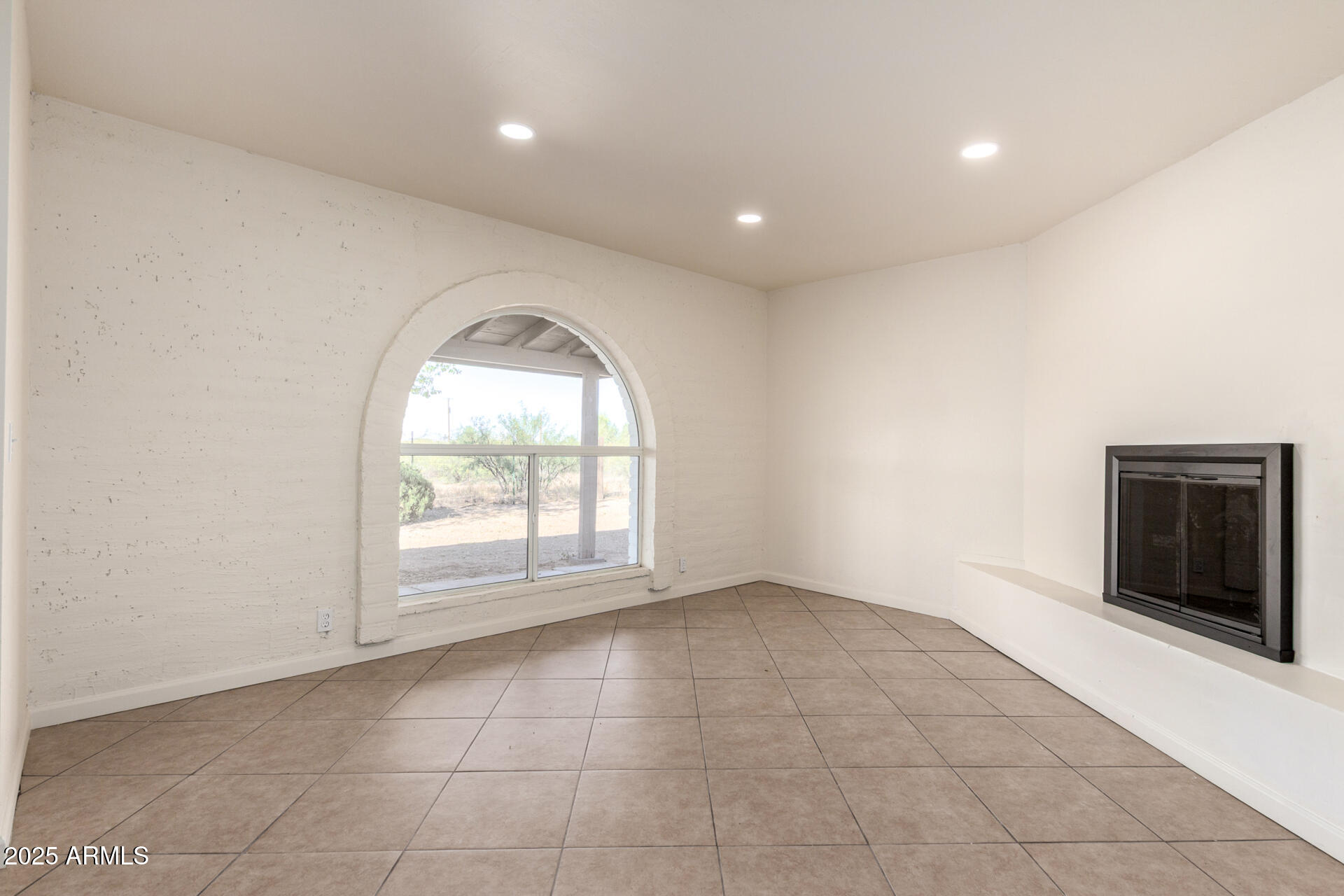 3613 East White Tail Road Pearce, AZ 85625 - Photo 8 of 39 an empty room with windows and fireplace