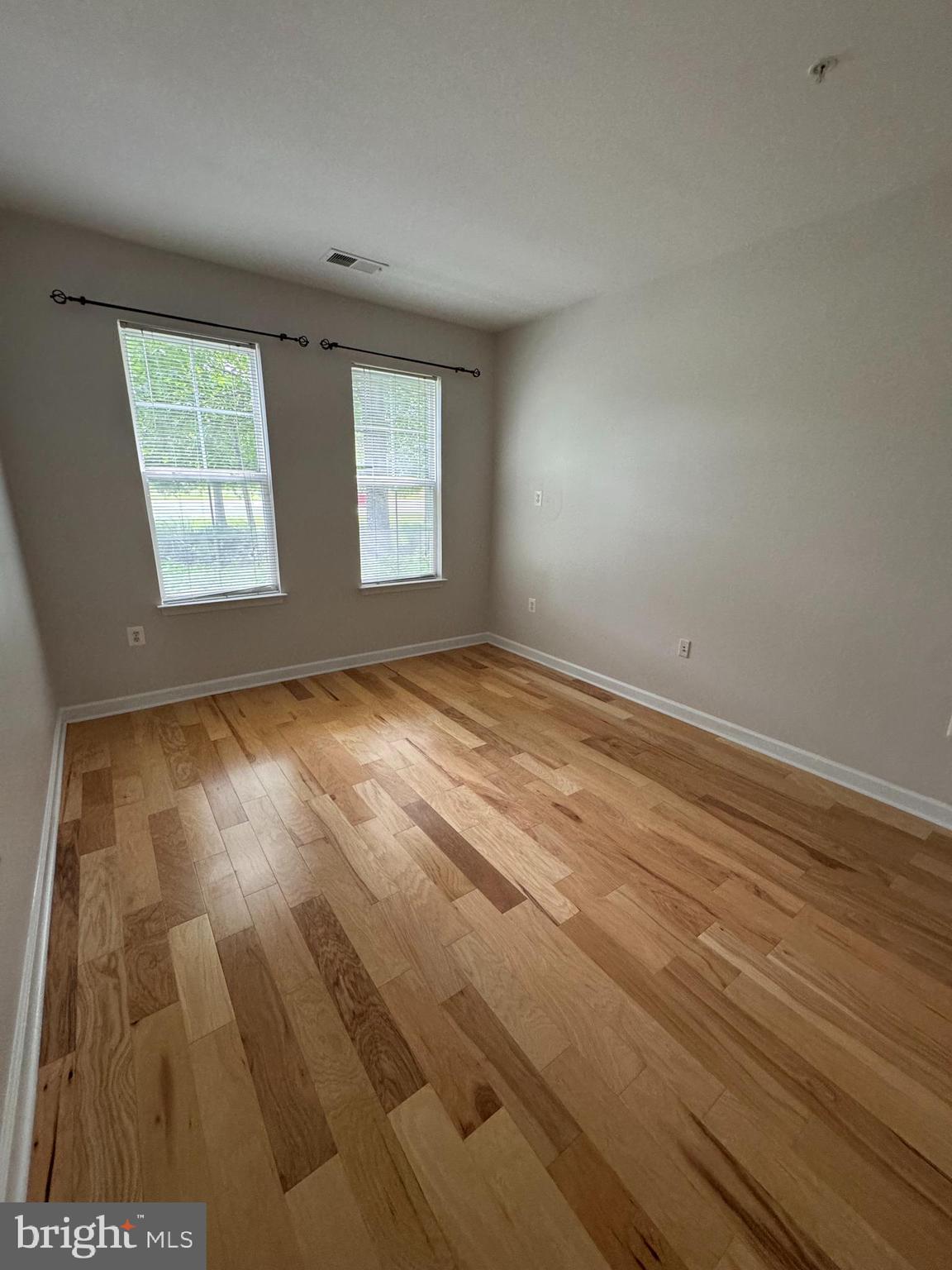 42429 Rockrose Square Brambleton, VA 20148 - Photo 13 of 13 an empty room with wooden floor and windows