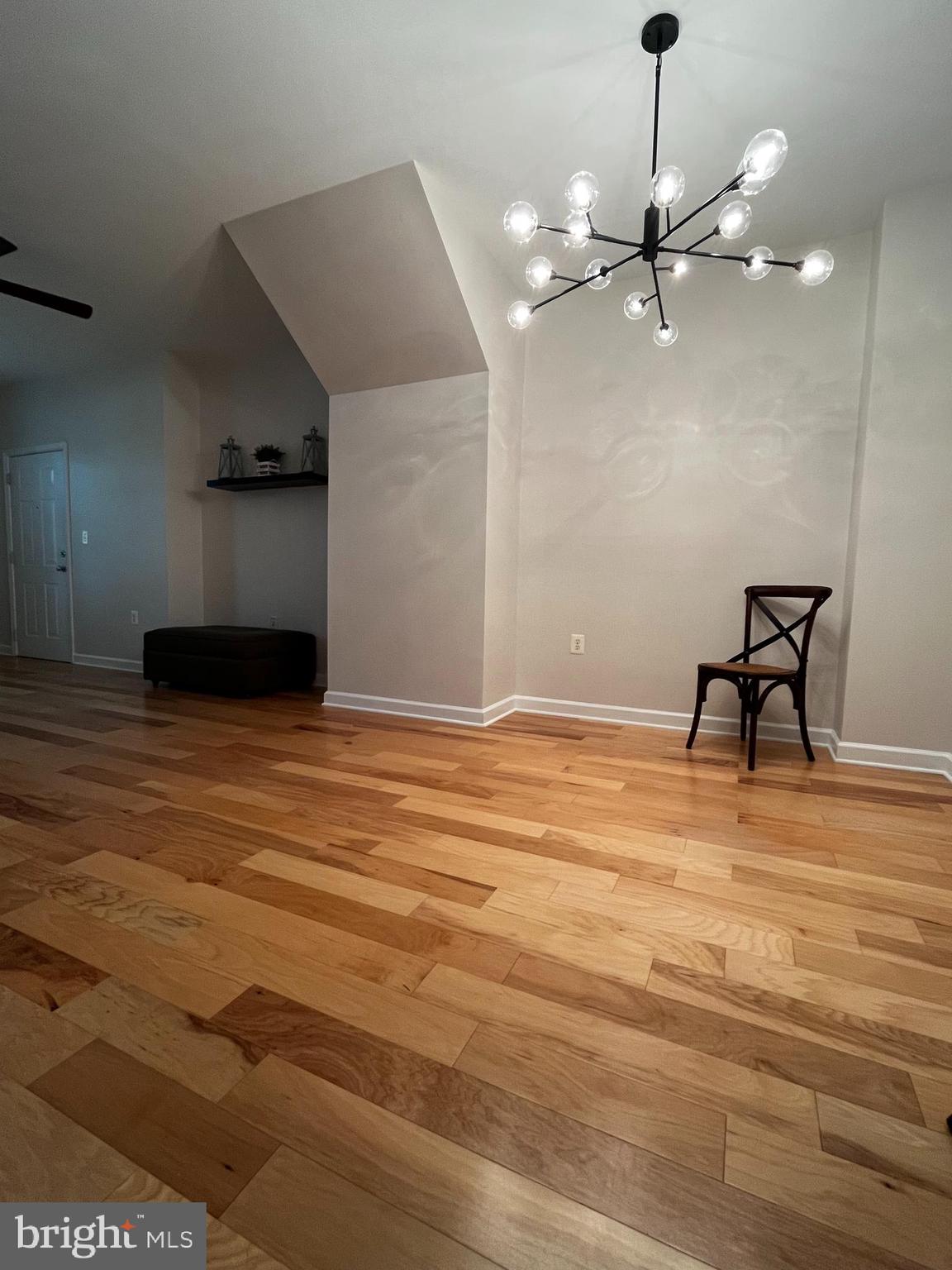 42429 Rockrose Square Brambleton, VA 20148 - Photo 5 of 13 a view of a room with a ceiling fan and hardwood floor