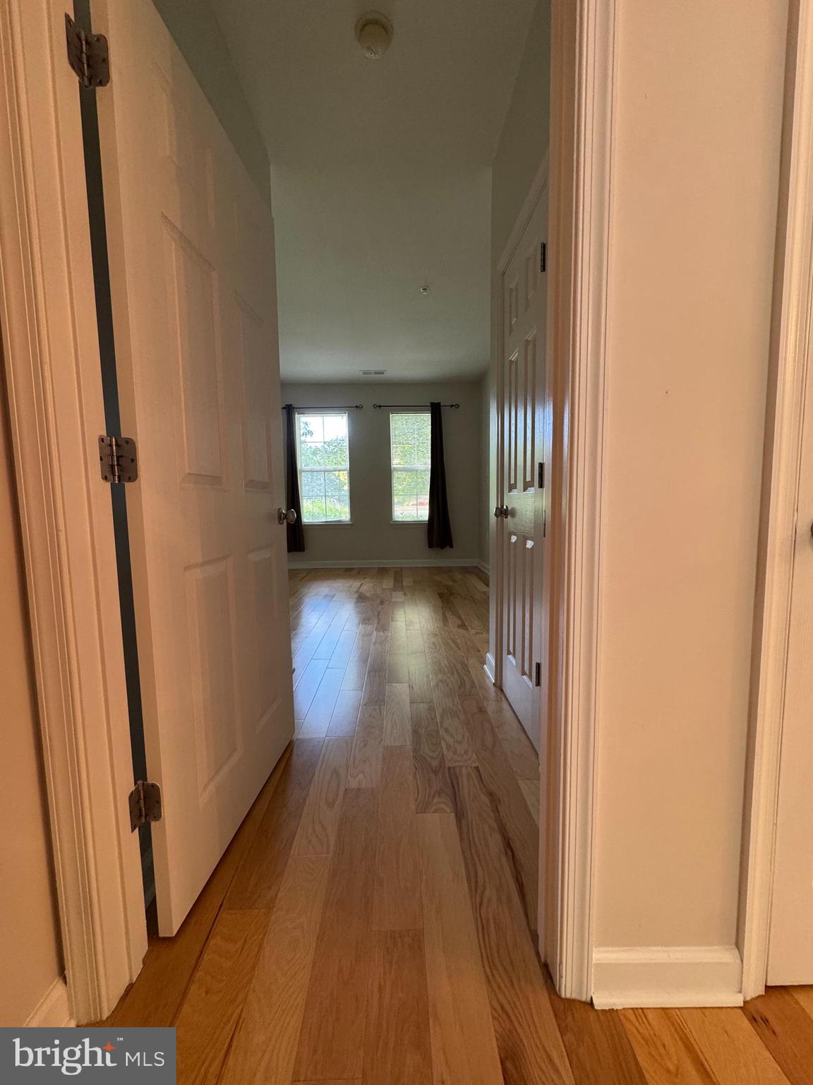 42429 Rockrose Square Brambleton, VA 20148 - Photo 8 of 13 a view of a hallway with wooden floor