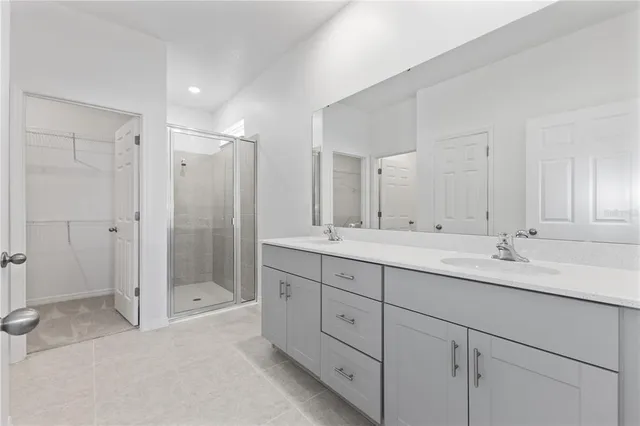 a bathroom with a shower sink double and mirror