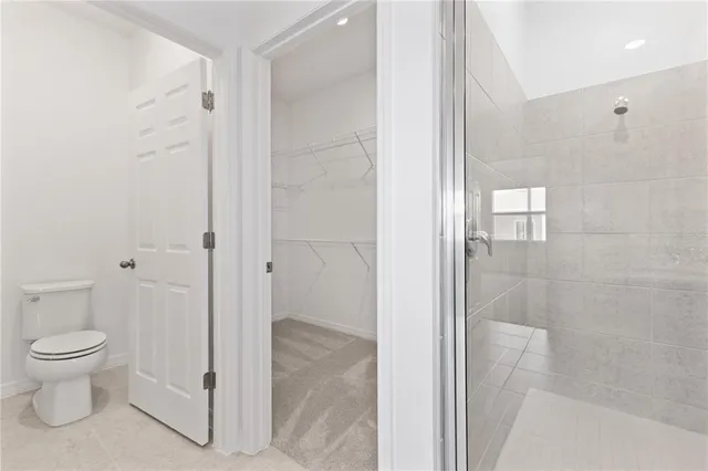 a bathroom with a toilet and a shower