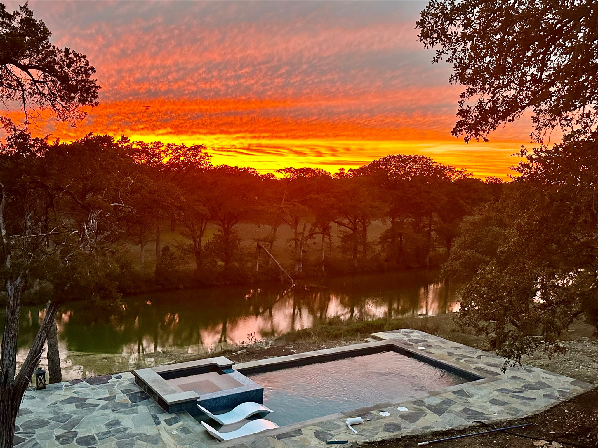710 Flite Acres Road Wimberley, TX 78676 - Photo 2 of 40 Evening sunset over the Blanco and the pool