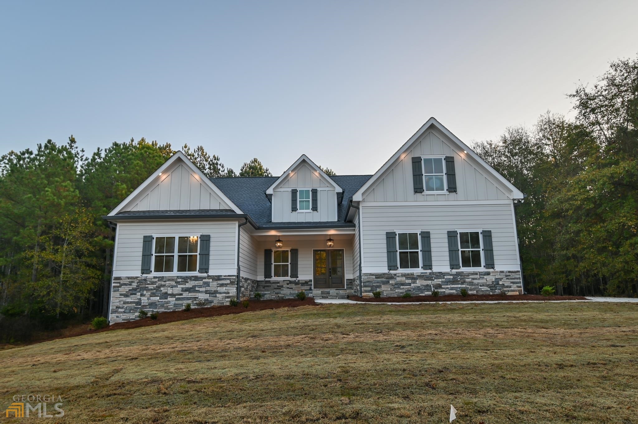 a front view of a house with a garden