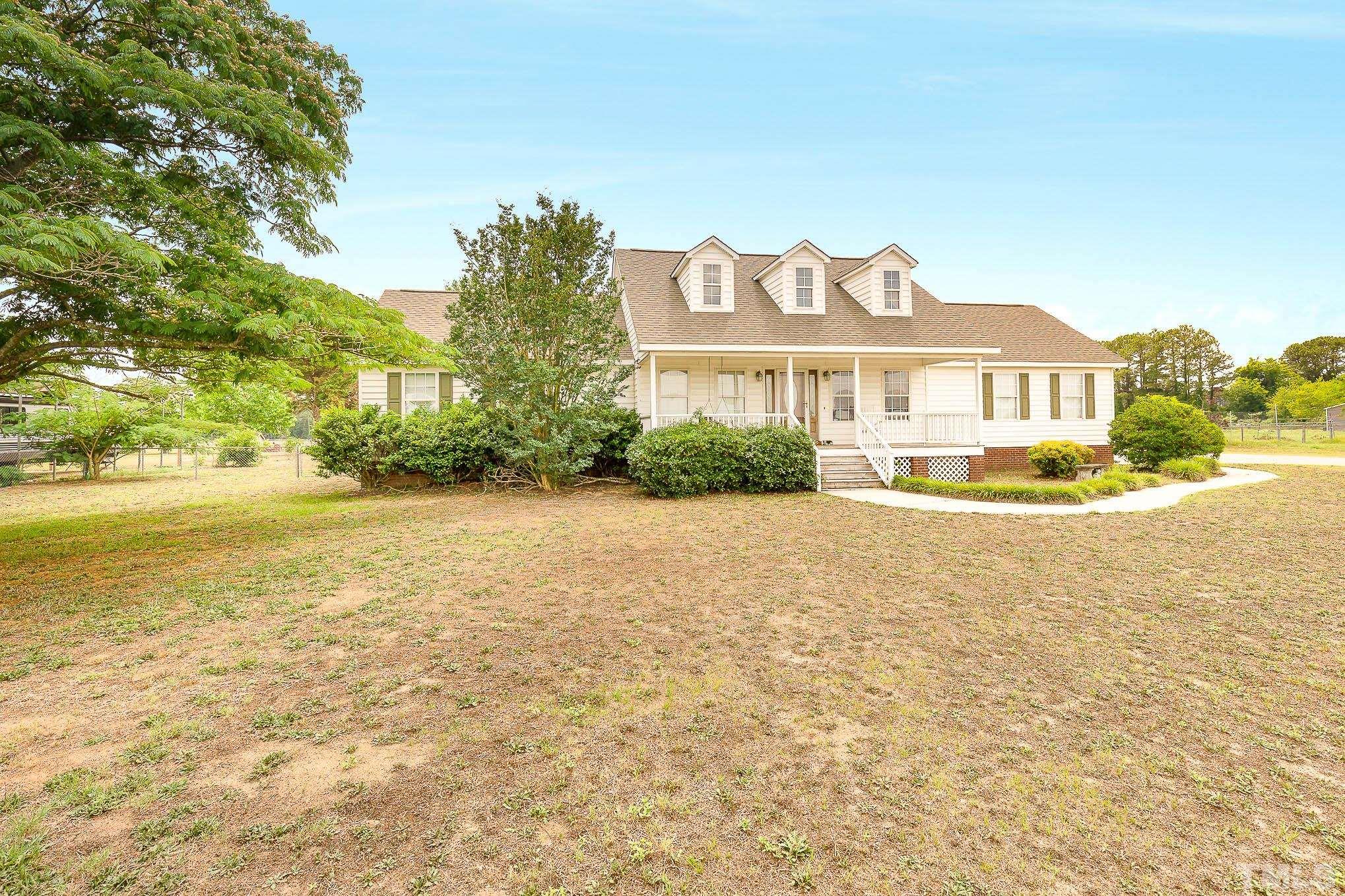 2809 Hayfield Road Wade, NC 28395 - Photo 3 of 22 a front view of a house with a yard and trees