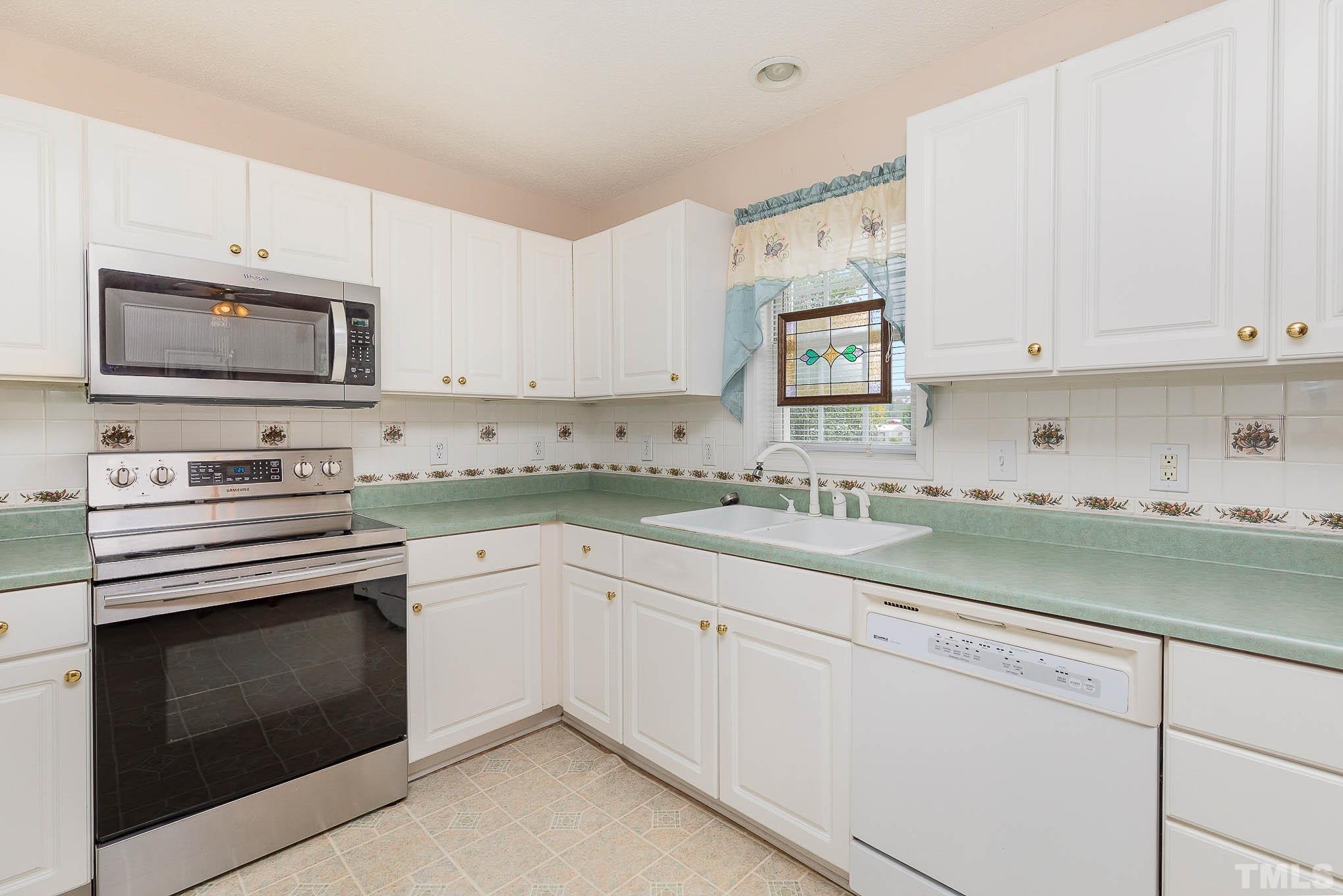 2809 Hayfield Road Wade, NC 28395 - Photo 6 of 22 a kitchen with granite countertop white cabinets white stainless steel appliances and a sink