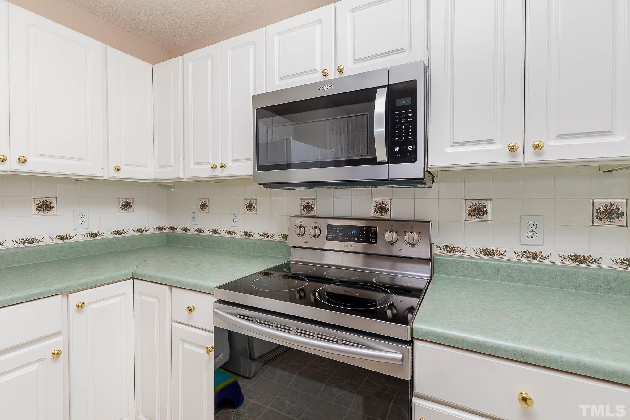 2809 Hayfield Road Wade, NC 28395 - Photo 8 of 22 a kitchen with microwave cabinets and a stove top oven