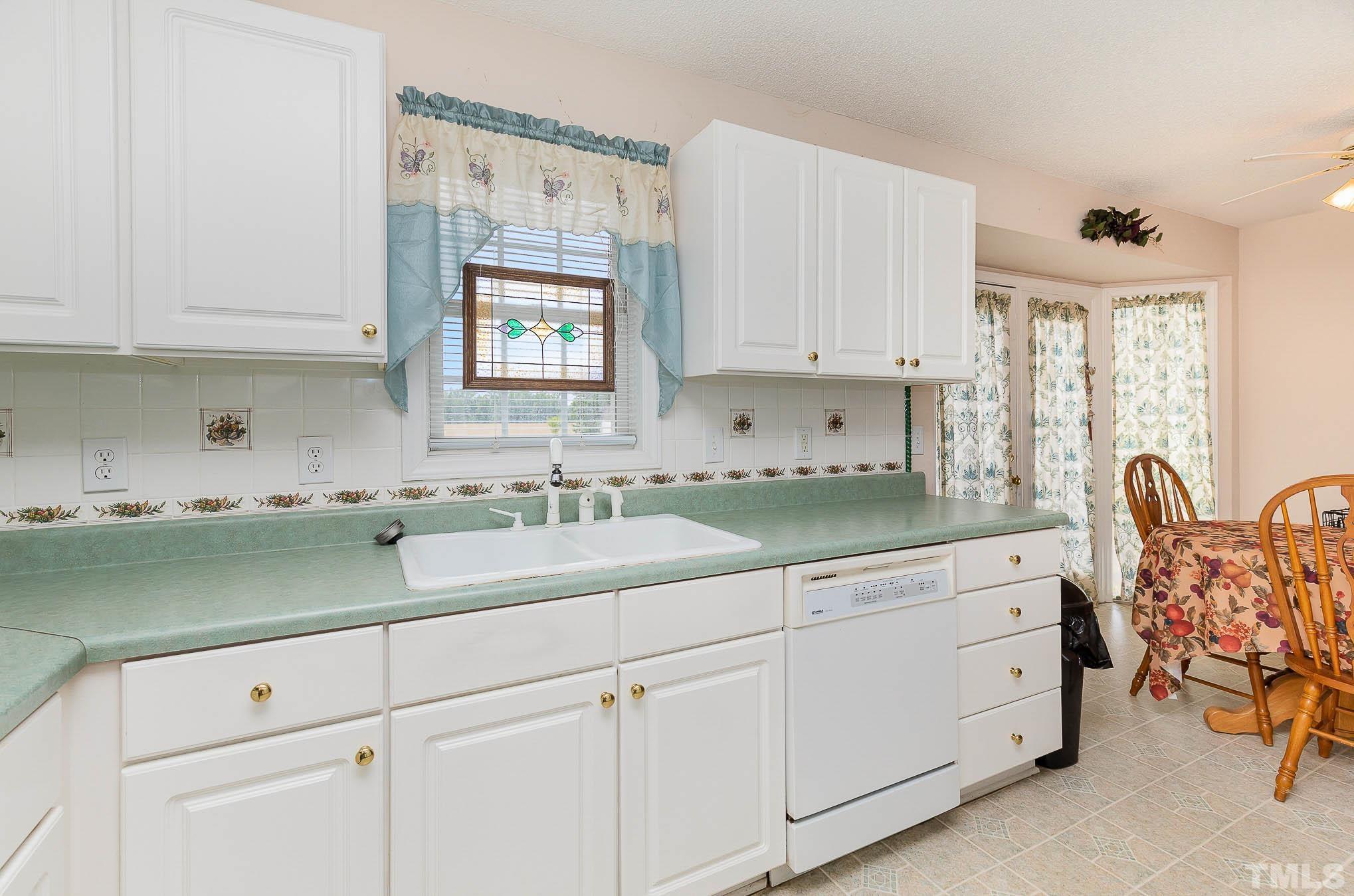 2809 Hayfield Road Wade, NC 28395 - Photo 9 of 22 a kitchen with white cabinets and sink