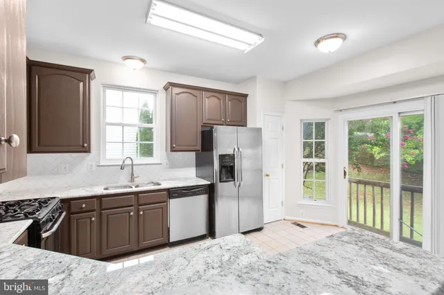 a kitchen with a sink stove and refrigerator