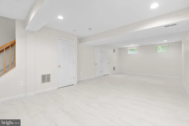 a bathroom with a granite countertop toilet a sink and mirror