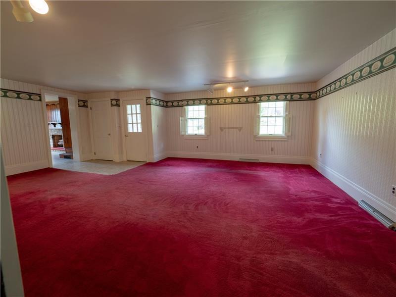 461 Lindsay Road Zelienople, PA 16063 - Photo 14 of 25 The expansive family room features access to the side porch and two + acres of land.