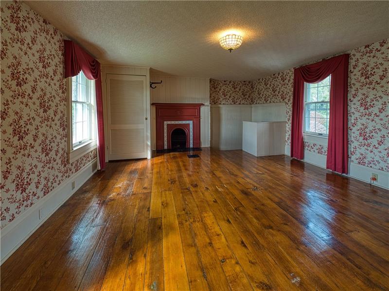 461 Lindsay Road Zelienople, PA 16063 - Photo 16 of 25 On the second level, the master bedroom boasts original hardwood flooring, large windows, ample storage, a fireplace and a secret staircase to the kitchen.
