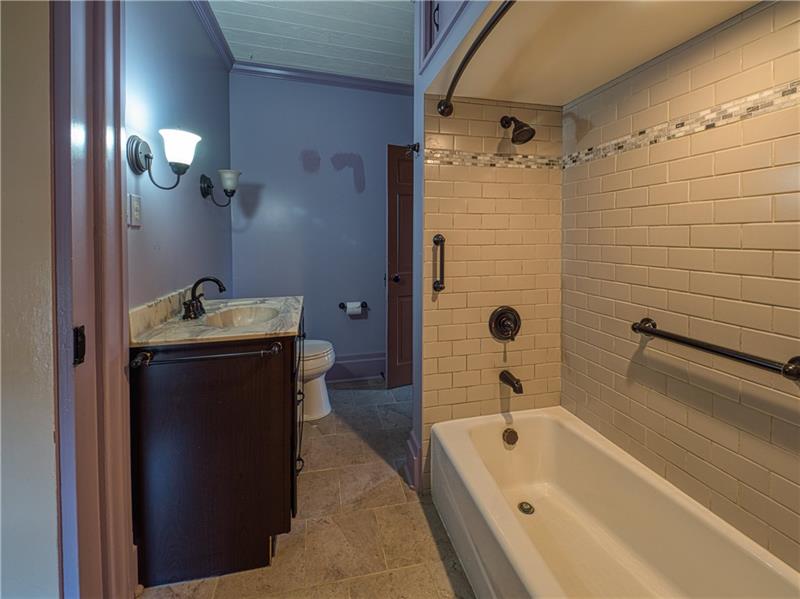 461 Lindsay Road Zelienople, PA 16063 - Photo 18 of 25 The updated hall bath is accessible from the master bedroom and has a tub/shower combo, custom vanity and modern style.