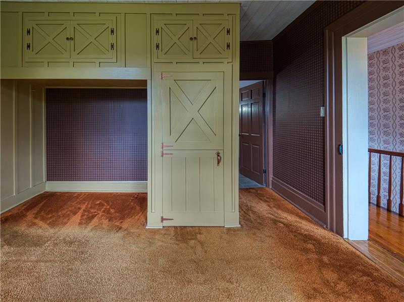 461 Lindsay Road Zelienople, PA 16063 - Photo 21 of 25 Roomy and well lit guest bedroom features custom storage and wood detailing.