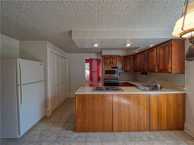 The kitchen features generous cabinetry and counter space.