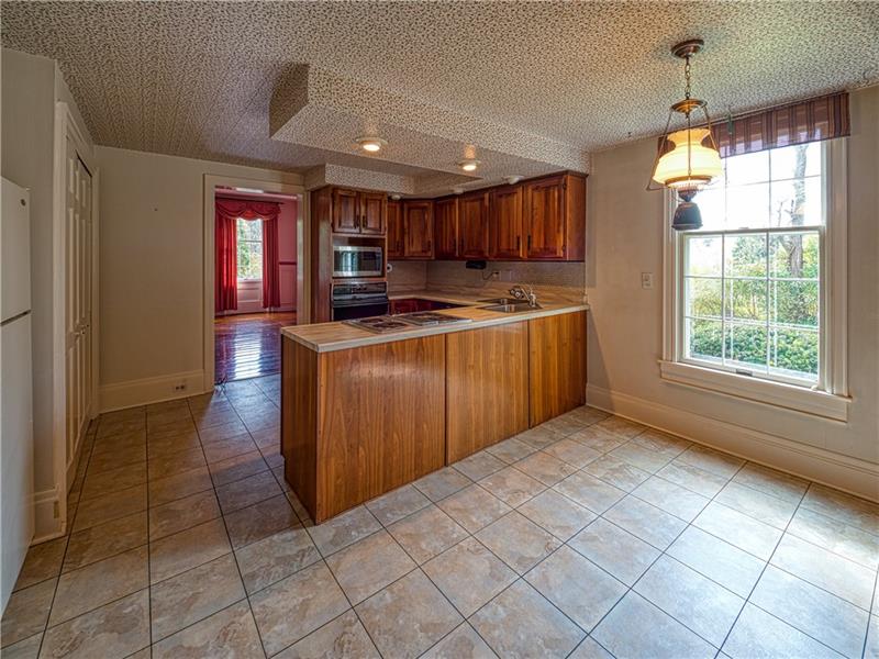 A large window floods the kitchen and casual dining area with natural sunlight.