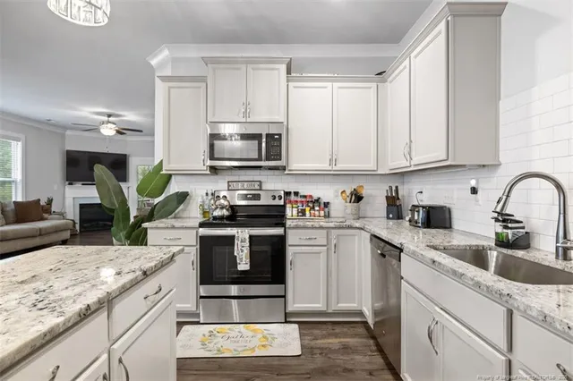 a kitchen with a sink stove and cabinets