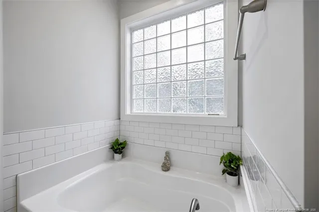 a white bath tub sitting next to a window