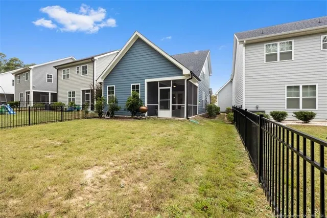 a view of a house with wooden fence