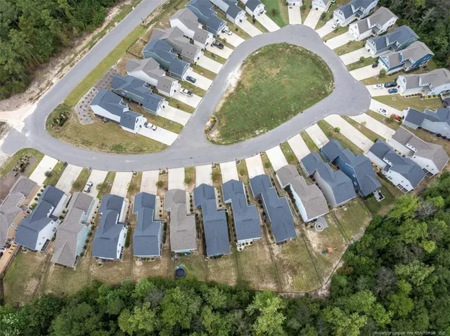 an aerial view of residential houses with outdoor space and seating