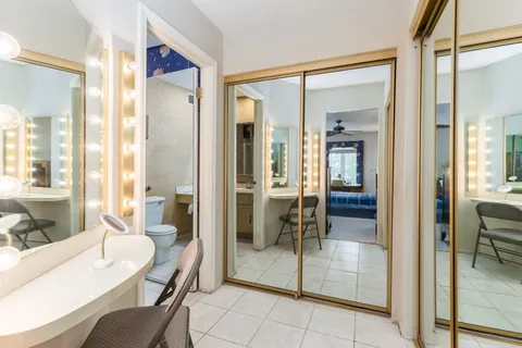 a view of a bathroom with tub shower and mirror