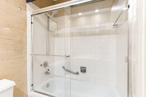 a bathroom with a glass shower door