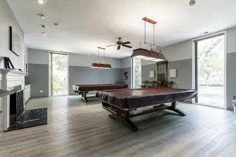 a living room with furniture a fireplace and a chandelier