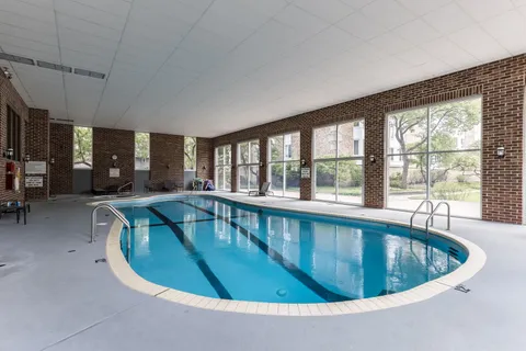 a view of a swimming pool with furniture