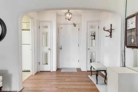 a view of a livingroom with wooden floor and a bathroom