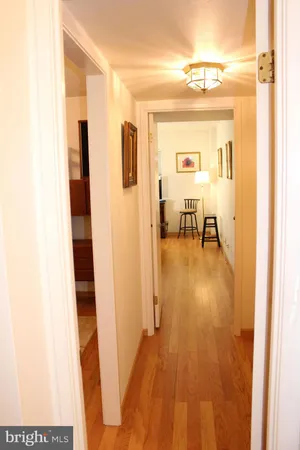 a view of a hallway with wooden floor