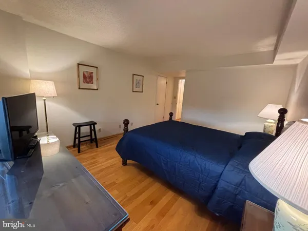 a bed room with a bed window and a television