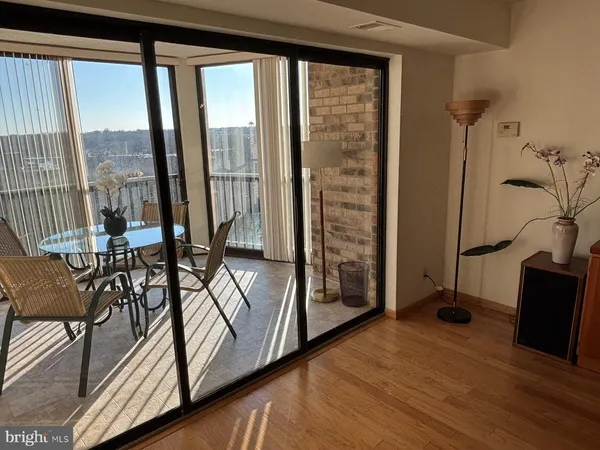 a view of a livingroom with furniture and a floor to ceiling window