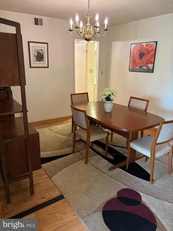 a view of a dining room with furniture and a chandelier