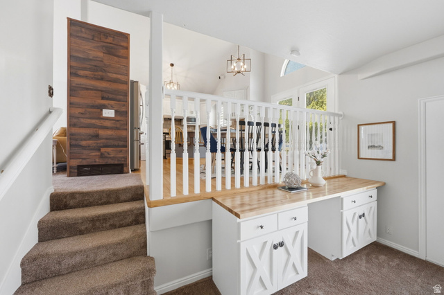 3732 Campbell Road Tooele, UT 84074 - Photo 23 of 69 Built-in desk with wood-finish countertop and white cabinetry with X-detail doors