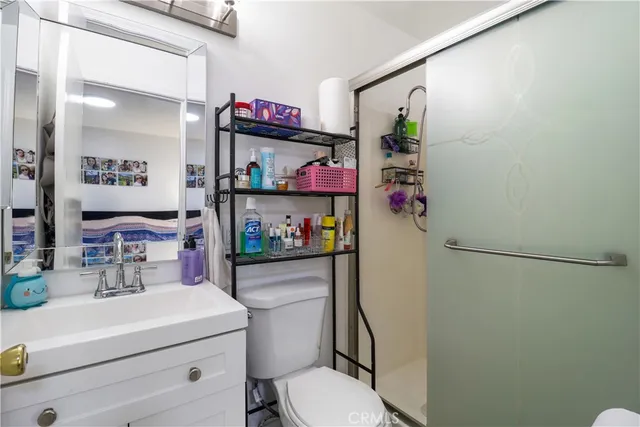 a bathroom with a sink toilet vanity and mirror
