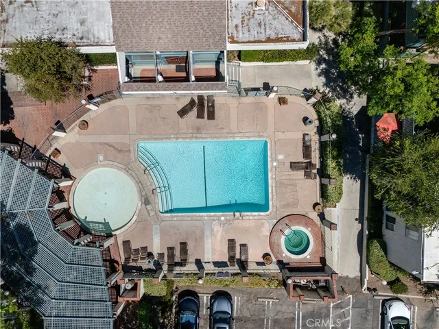 an aerial view of a house with swimming pool and outdoor seating