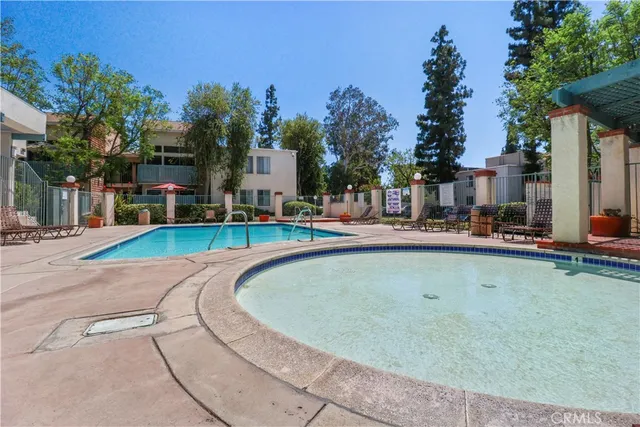 a swimming pool with outdoor seating and yard