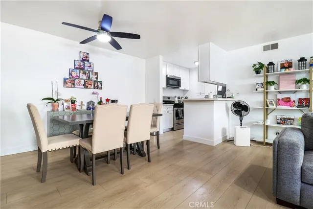 a view of a dining room with furniture and wooden floor